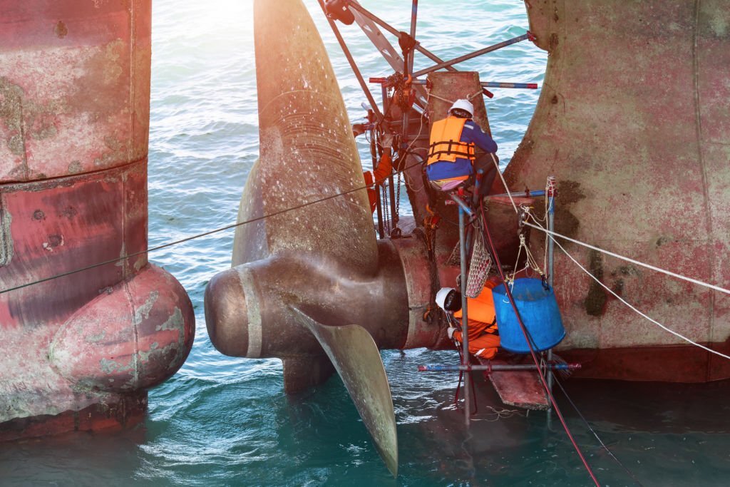 repairing and replacement of shaft on propeller of the ship in medsea port terminal by the workers and technician
